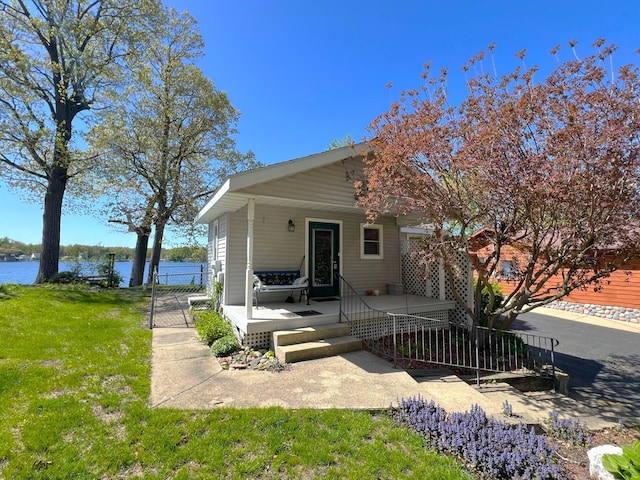 63568 Zabel Shores Rd, Sturgis, MI 49091 - rear view of property with a water view, covered porch, and a yard