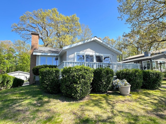 63568 Zabel Shores Rd, Sturgis, MI 49091 - rear view of house featuring a chimney and a lawn