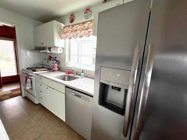 63568 Zabel Shores Rd, Sturgis, MI 49091 - kitchen featuring stainless steel appliances, a sink, white cabinets, backsplash, and light flooring