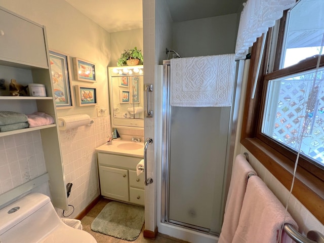 63568 Zabel Shores Rd, Sturgis, MI 49091 - full bath featuring tile walls, a shower stall, vanity, toilet, and tile patterned floors