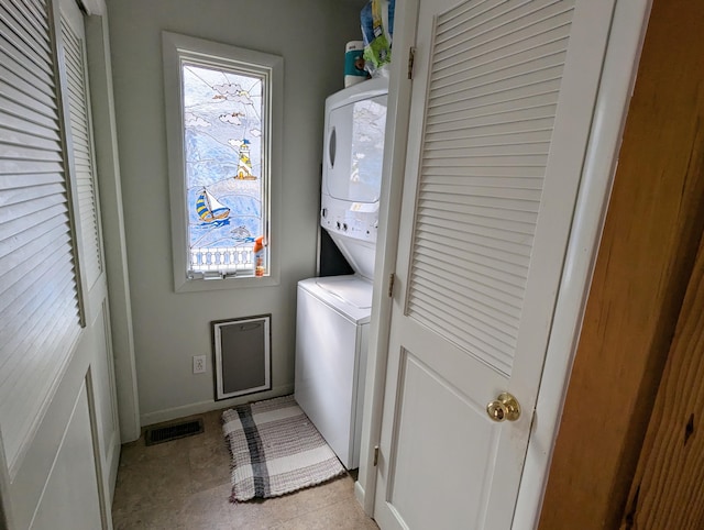 63568 Zabel Shores Rd, Sturgis, MI 49091 - clothes washing area featuring stacked washer / drying machine and baseboards