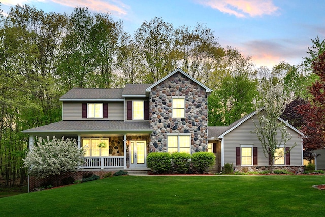 3135 Walnut Hls, Leonard, MI 48367 - view of front of house featuring stone siding, a porch, a yard, and a shingled roof
