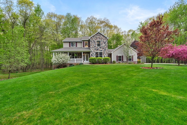 3135 Walnut Hls, Leonard, MI 48367 - view of front of home with stone siding, a porch, and a front lawn