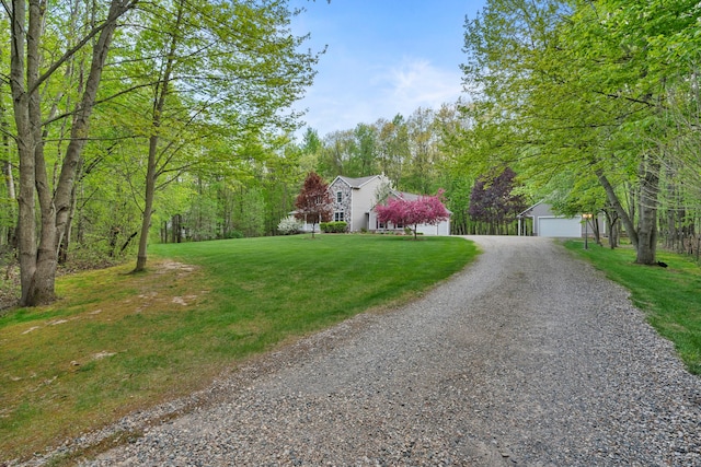 3135 Walnut Hls, Leonard, MI 48367 - view of front of property with gravel driveway, an outbuilding, a front lawn, and a garage