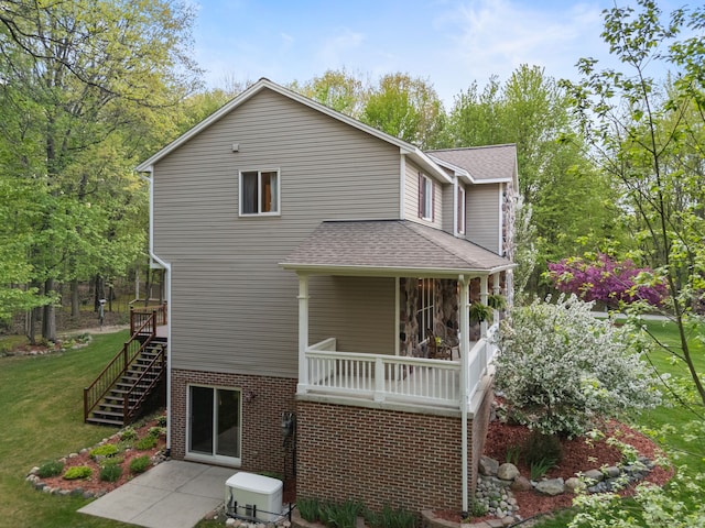 3135 Walnut Hls, Leonard, MI 48367 - back of house featuring a lawn, stairs, and a shingled roof
