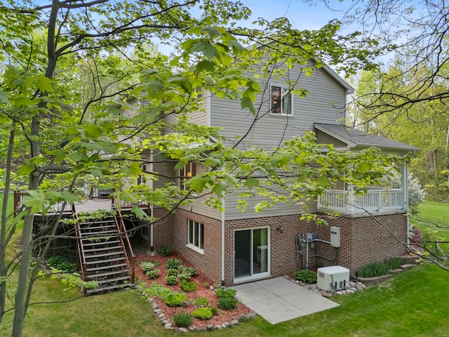 3135 Walnut Hls, Leonard, MI 48367 - back of house with a lawn, a patio area, stairway, and brick siding