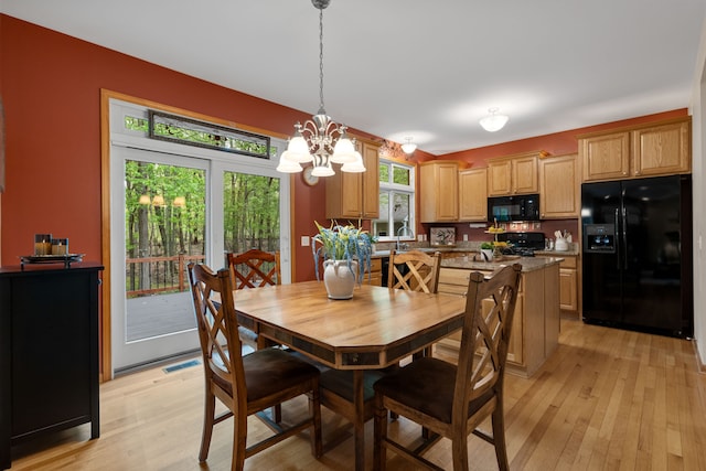3135 Walnut Hls, Leonard, MI 48367 - dining room with light wood-style flooring and a chandelier