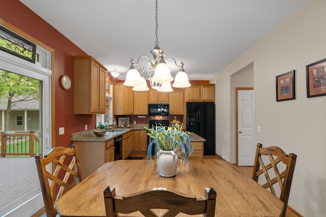 3135 Walnut Hls, Leonard, MI 48367 - dining area featuring a chandelier, light wood-style flooring, and baseboards