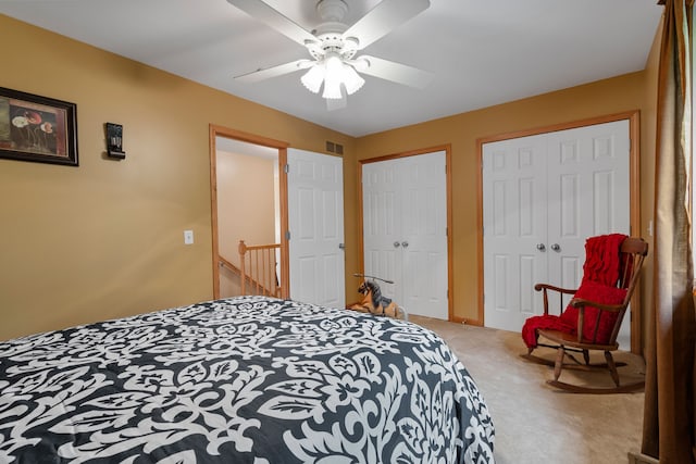 3135 Walnut Hls, Leonard, MI 48367 - bedroom with multiple closets, carpet, and ceiling fan