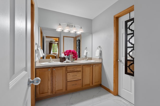 3135 Walnut Hls, Leonard, MI 48367 - bathroom featuring ensuite bath, double vanity, marble finish flooring, and baseboards