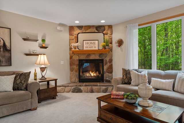 3135 Walnut Hls, Leonard, MI 48367 - carpeted living area featuring a stone fireplace and recessed lighting