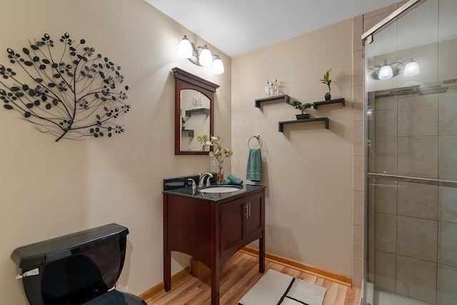 3135 Walnut Hls, Leonard, MI 48367 - bathroom featuring wood finished floors, a stall shower, vanity, and baseboards