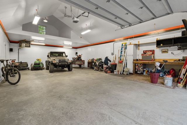 3135 Walnut Hls, Leonard, MI 48367 - garage with a garage door opener and a workshop area