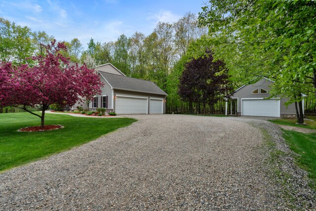 3135 Walnut Hls, Leonard, MI 48367 - view of front of home with a front yard, driveway, and a detached garage
