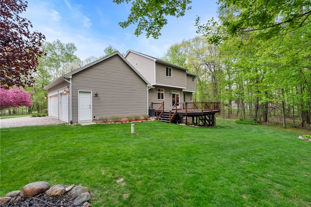 3135 Walnut Hls, Leonard, MI 48367 - back of house with gravel driveway, a deck, a lawn, and a garage