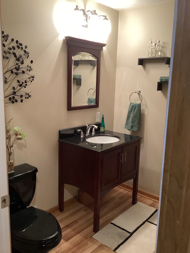 3135 Walnut Hls, Leonard, MI 48367 - bathroom with wood finished floors, vanity, baseboards, and toilet