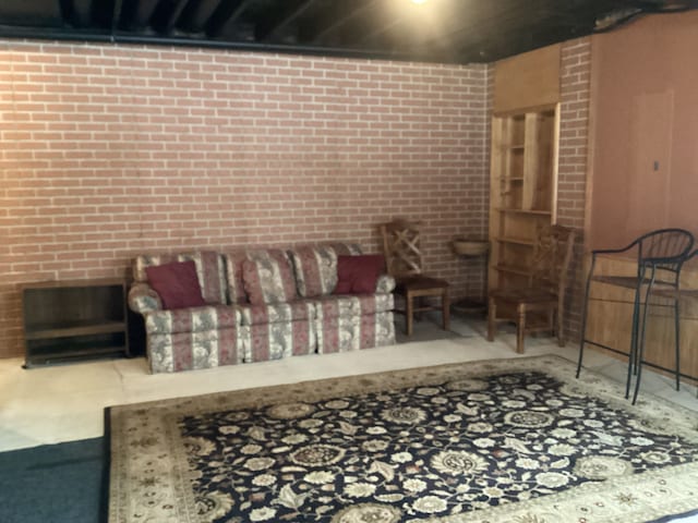 3135 Walnut Hls, Leonard, MI 48367 - living area with brick wall