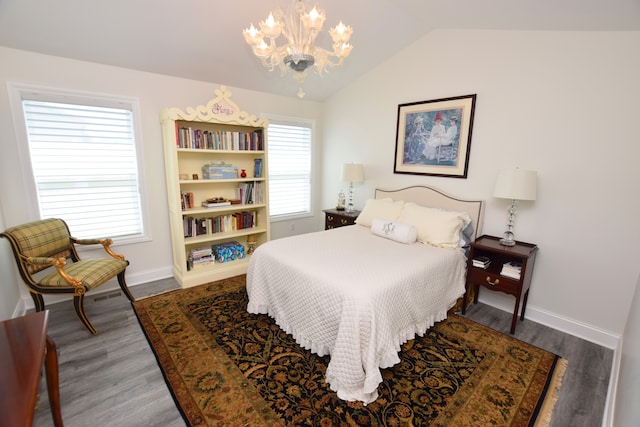 9466 Heritage, Goodrich, MI 48438 - bedroom featuring a chandelier, wood finished floors, baseboards, and lofted ceiling
