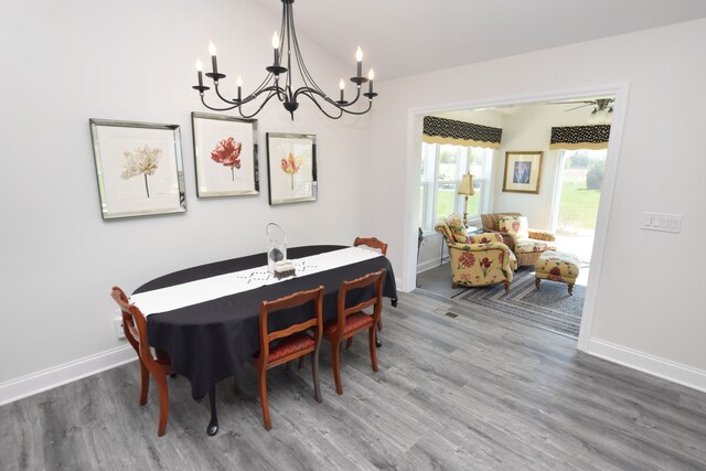 9466 Heritage, Goodrich, MI 48438 - dining area featuring a chandelier, wood finished floors, baseboards, and vaulted ceiling