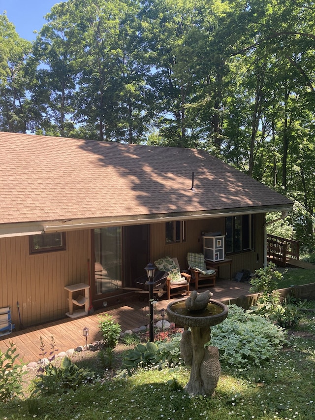 1548 Sunterra Trl, Boyne City, MI 49712 - back of property with roof with shingles and a wooden deck