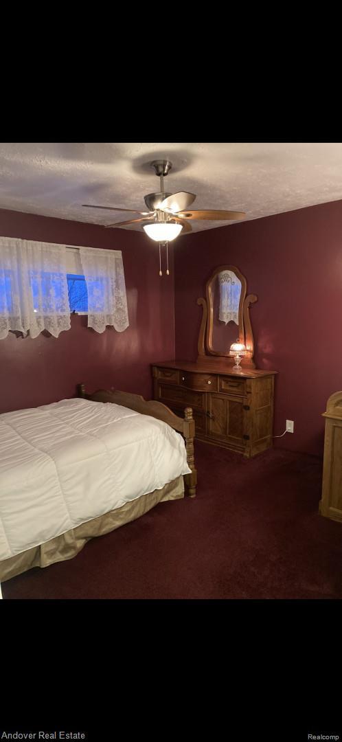 1548 Sunterra Trl, Boyne City, MI 49712 - carpeted bedroom with a ceiling fan