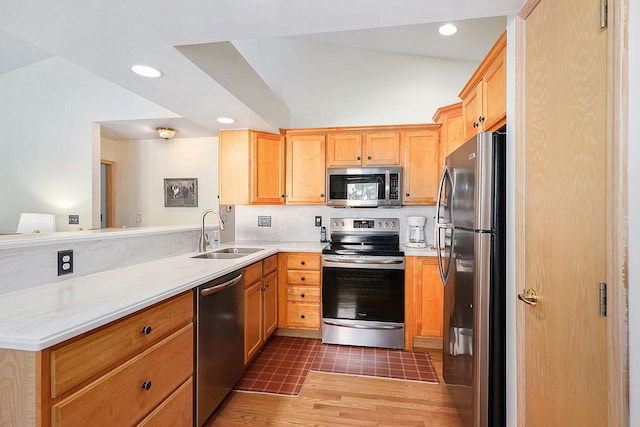9098 Luea Ln, Swartz Creek, MI 48473 - kitchen with appliances with stainless steel finishes, a sink, light wood-style flooring, recessed lighting, and light brown cabinetry