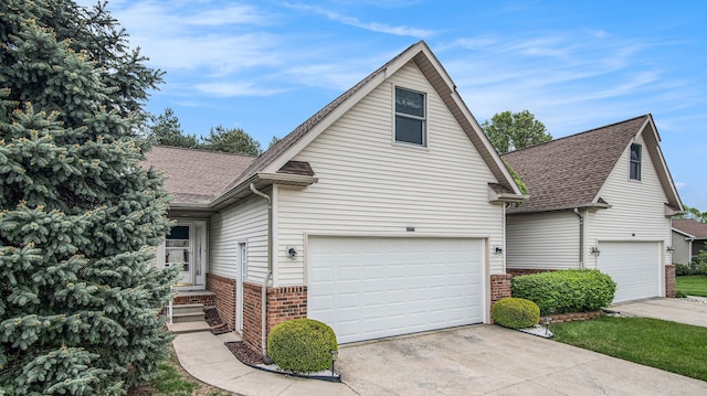 9098 Luea Ln, Swartz Creek, MI 48473 - view of front facade featuring brick siding, a shingled roof, driveway, and a garage