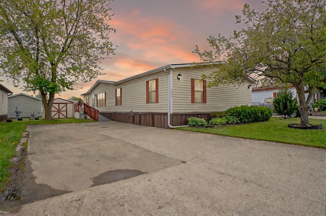 14424 Grenwich Ct, Shelby Twp, MI 48315 - manufactured / mobile home featuring a lawn, an outdoor structure, and a shed