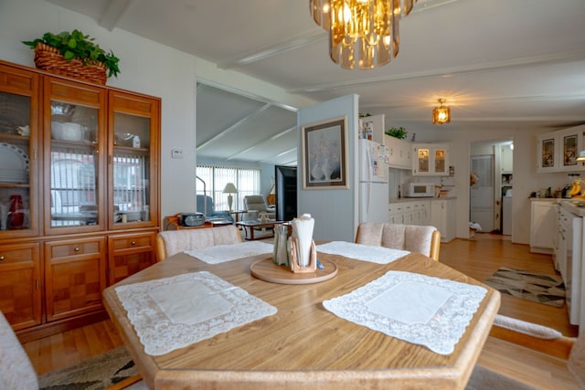 14424 Grenwich Ct, Shelby Twp, MI 48315 - dining space with light wood finished floors and a chandelier