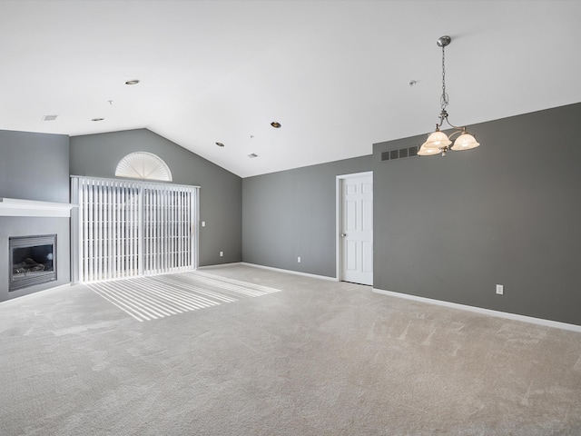 unfurnished living room with lofted ceiling, carpet floors, a glass covered fireplace, and baseboards
