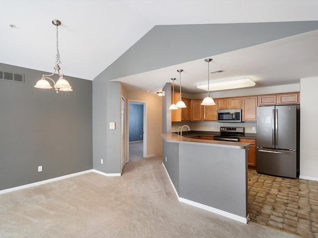 kitchen featuring appliances with stainless steel finishes, vaulted ceiling, a peninsula, decorative light fixtures, and baseboards