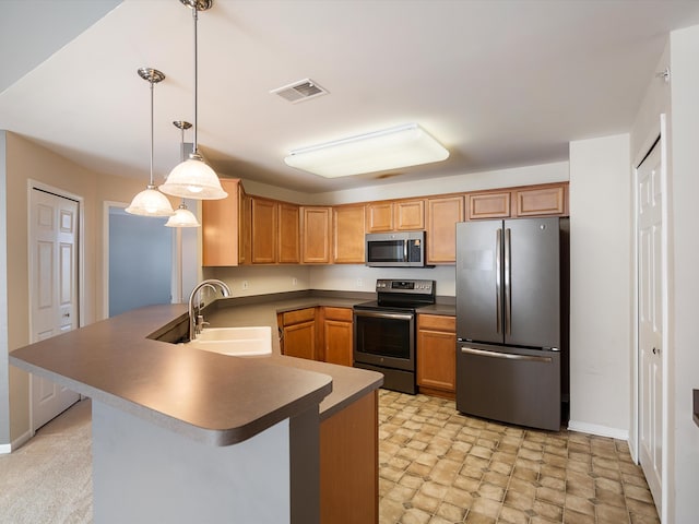 kitchen with stainless steel appliances, a sink, a peninsula, and baseboards