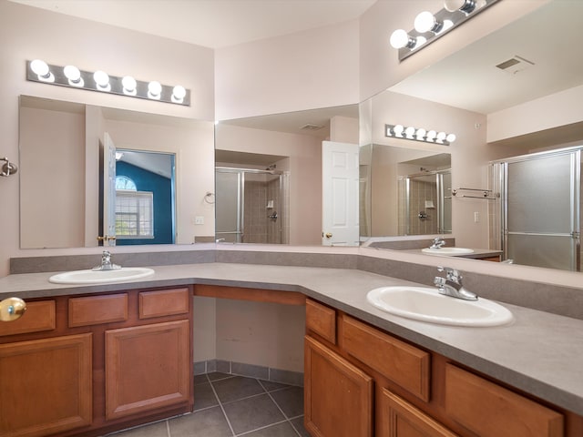 full bathroom with a shower stall, tile patterned flooring, and double vanity