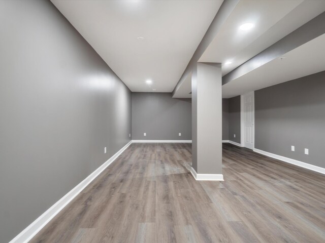 finished below grade area with wood finished floors, baseboards, and recessed lighting