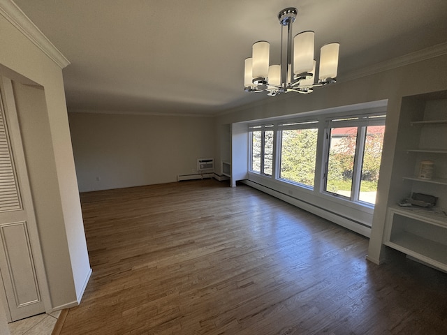 unfurnished dining area featuring ornamental molding, a baseboard heating unit, a chandelier, wood finished floors, and baseboards