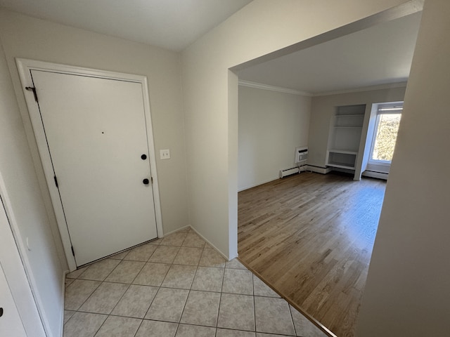 entrance foyer featuring ornamental molding, light wood-style flooring, baseboard heating, and baseboards