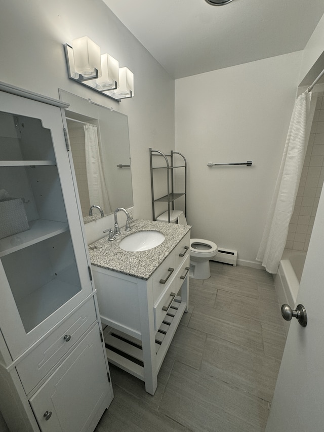 bathroom with a baseboard heating unit, vanity, toilet, and tile patterned flooring