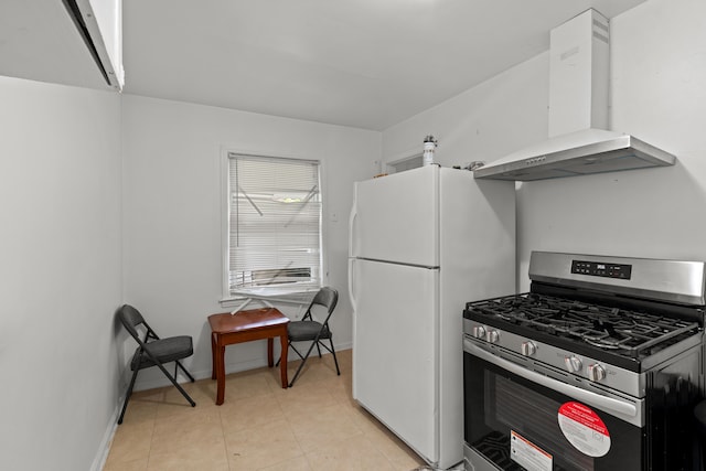 17041 Henry St, Melvindale, MI 48122 - kitchen featuring gas range, wall chimney range hood, freestanding refrigerator, baseboards, and light tile patterned flooring