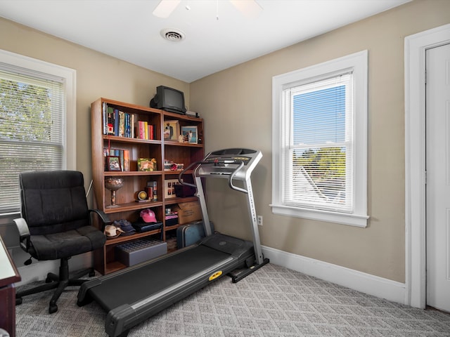 workout area featuring carpet flooring, baseboards, and ceiling fan
