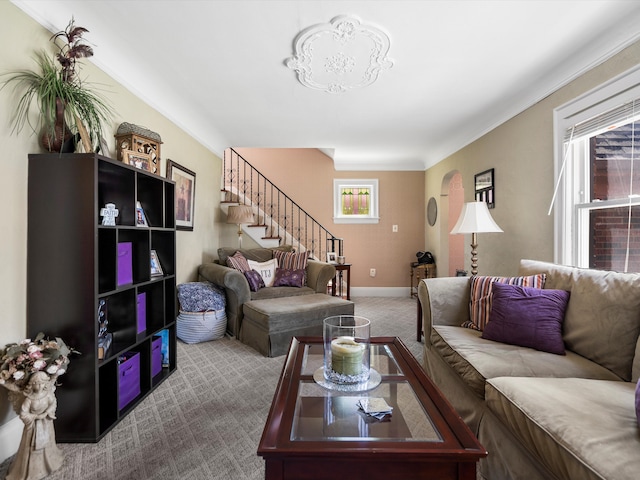 living room with stairs, carpet floors, and baseboards