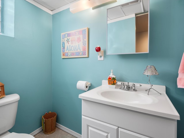bathroom featuring toilet, vanity, and baseboards