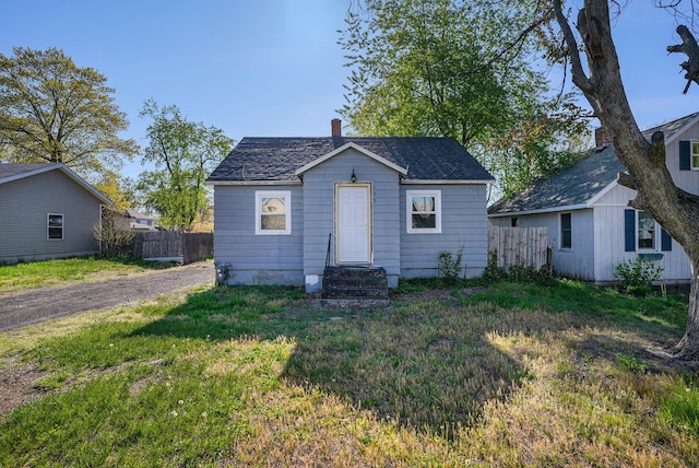 bungalow featuring entry steps and roof with shingles