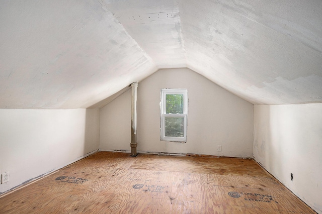additional living space featuring lofted ceiling