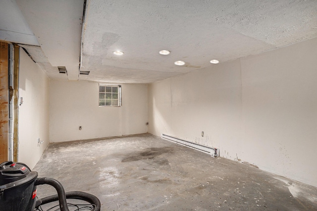 below grade area featuring a baseboard radiator and recessed lighting