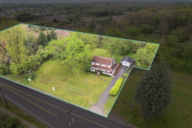 view of rural area featuring property boundaries highlighted and a heavily wooded area