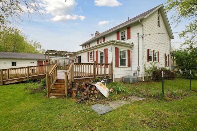 rear view of property featuring a deck, a pergola, a yard, cooling unit, and a chimney