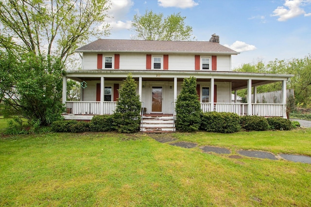 farmhouse inspired home featuring a chimney, a porch, and a front yard