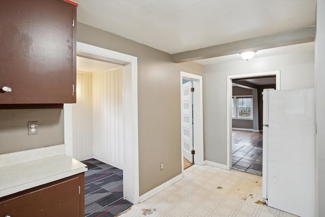 hall with light floors and baseboards
