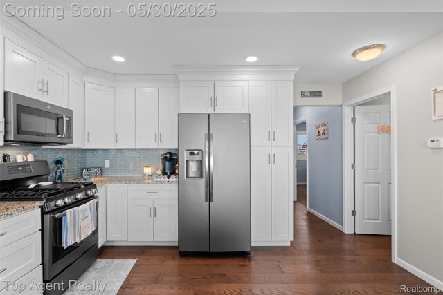 7910 Anchor Bay Dr, Clay, MI 48001 - kitchen with stainless steel appliances, dark wood-style flooring, white cabinetry, tasteful backsplash, and recessed lighting