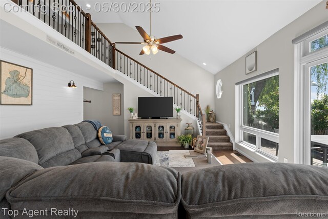 7910 Anchor Bay Dr, Clay, MI 48001 - living area featuring stairway, a ceiling fan, high vaulted ceiling, wood finished floors, and recessed lighting